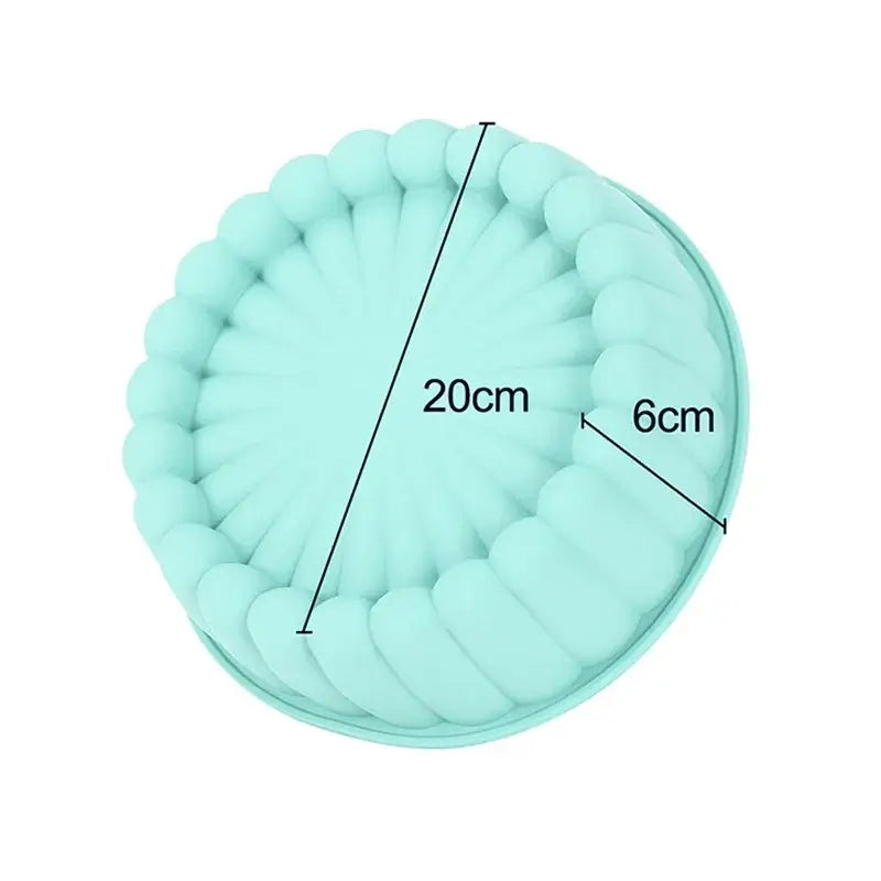 Moule à charlotte en silicone bleu avec des bords ondulés. Le diamètre du moule est indiqué à 20 cm, avec une hauteur de 6 cm.